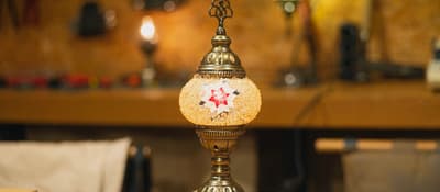 Finished mosaic lamp with a glowing red-and-white star made at a workshop in Istanbul