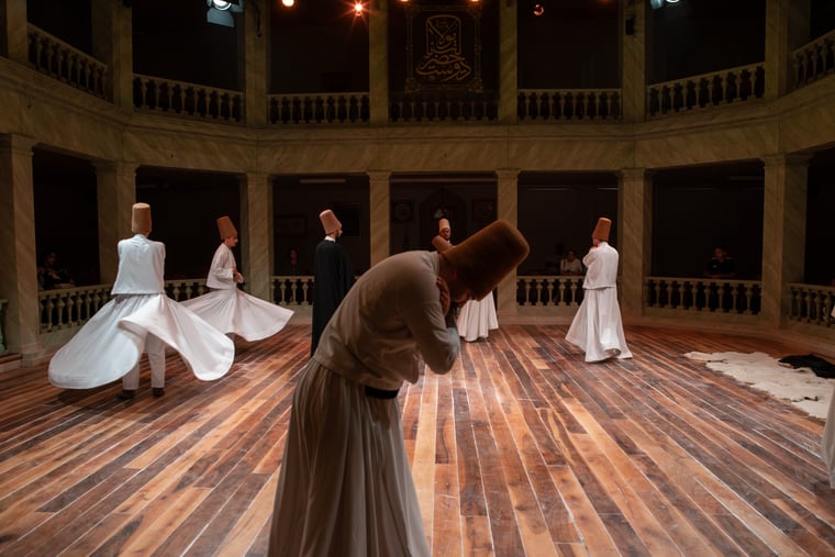 Semazens whirling during the third salam at Kasımpaşa Mevlevihanesi
