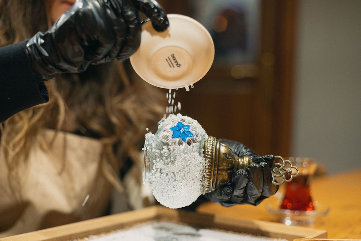 A small group crafting mosaic lamps together in a warm Istanbul studio
