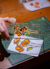 Hand-painting a colourful floral stained glass panel at an Istanbul stained glass workshop