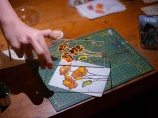 Hand-painting a colourful floral stained glass panel at an Istanbul stained glass workshop