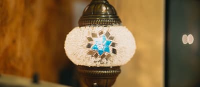 Hanging mosaic lamp with a blue mirror-tile star from a lamp workshop in Istanbul