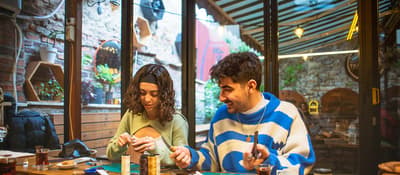 Participants crafting leather goods by the window at an Istanbul leather workshop