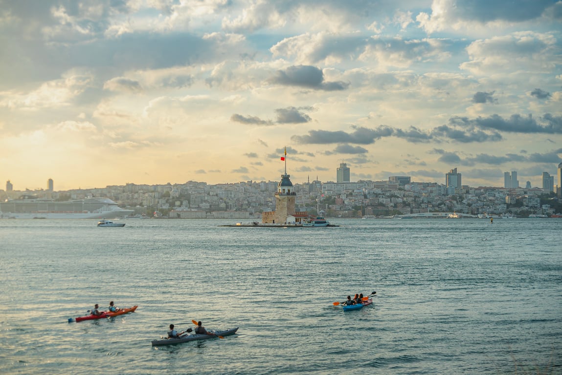 A small group of canoes on the water together with their guide