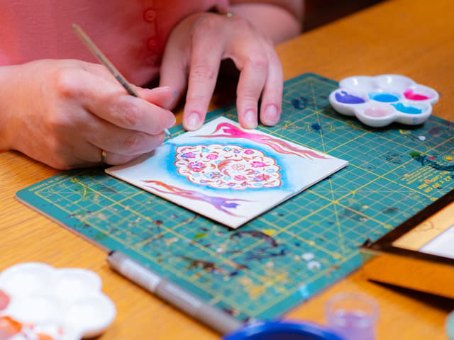 Painting a floral motif at a Turkish illumination (tezhip) art workshop in Istanbul