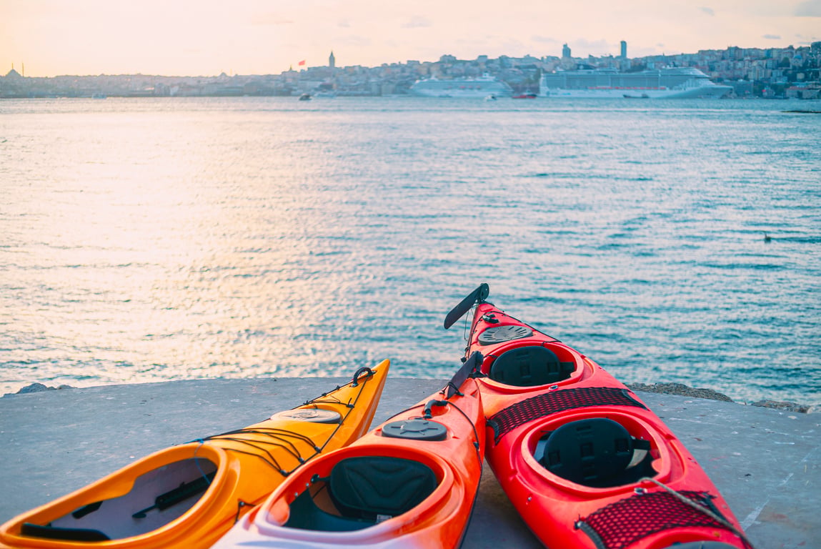 Two paddlers gliding past the Salacak shore in Üsküdar on a calm morning