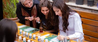 Friends painting together at a traditional stained glass workshop in Istanbul